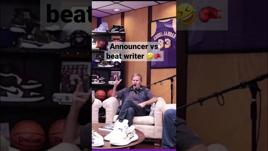 A man discusses music production on a podcast set with recording equipment around.