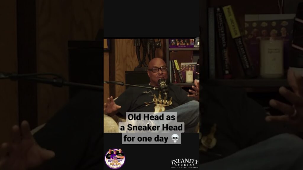 A man sitting and speaking in a podcast or interview setting.