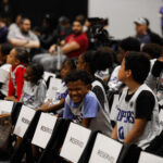 Young basketball players eagerly await their turn at a sports event.