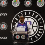Person speaking at a Clippers press conference podium.