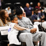 A man, woman, and child share a quiet moment in a reserved seating area.