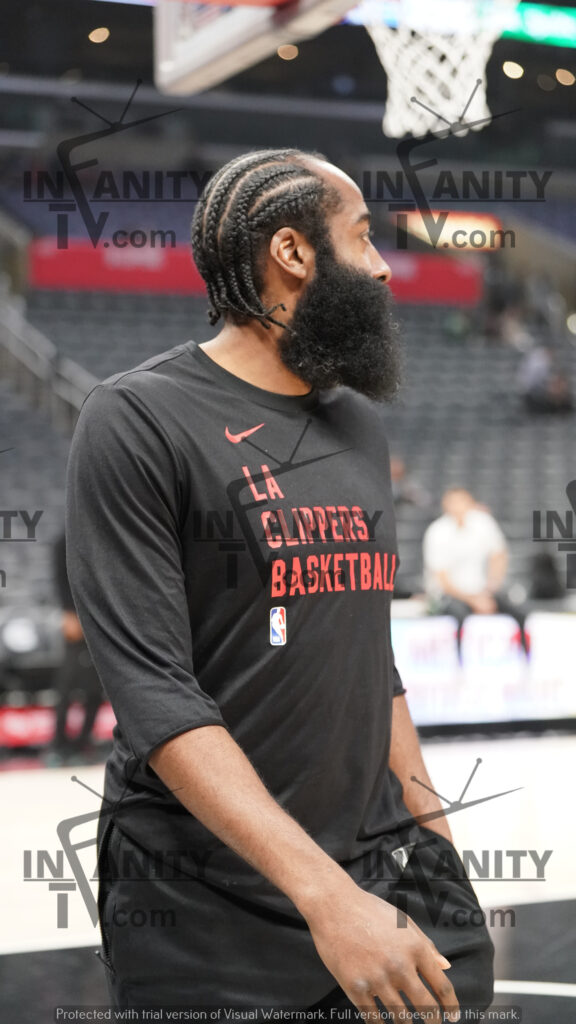Basketball player in warm-up gear on the court.