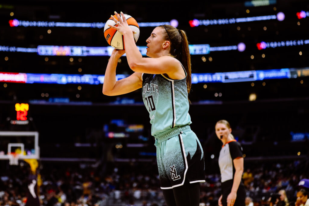 Female basketball player preparing to shoot during a game.