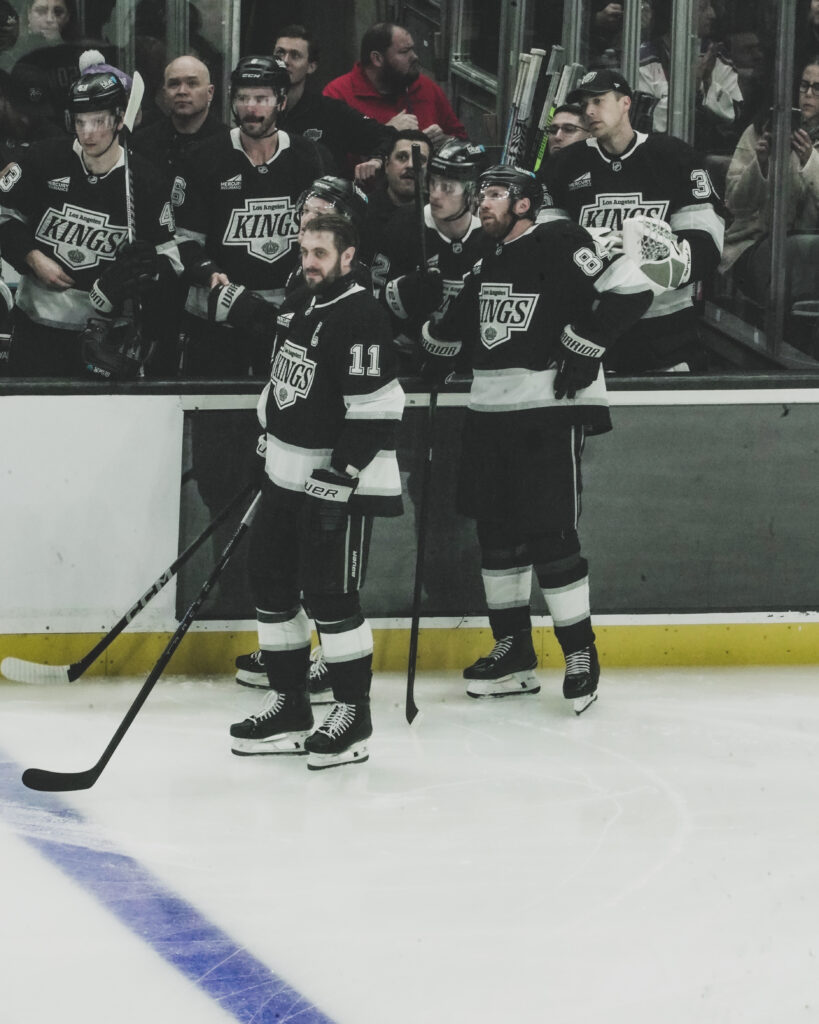 Hockey players gathered on the ice during a game break.