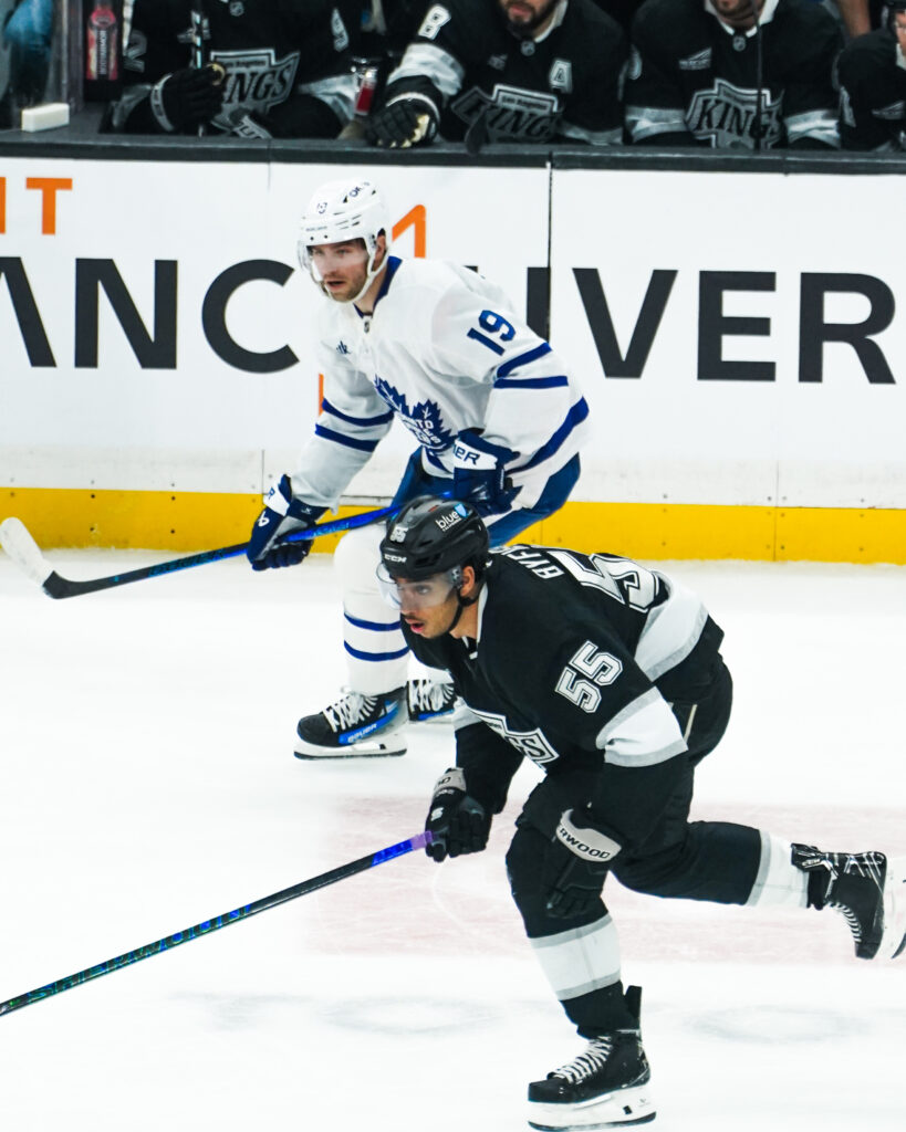 Two ice hockey players competing intensely during a game.