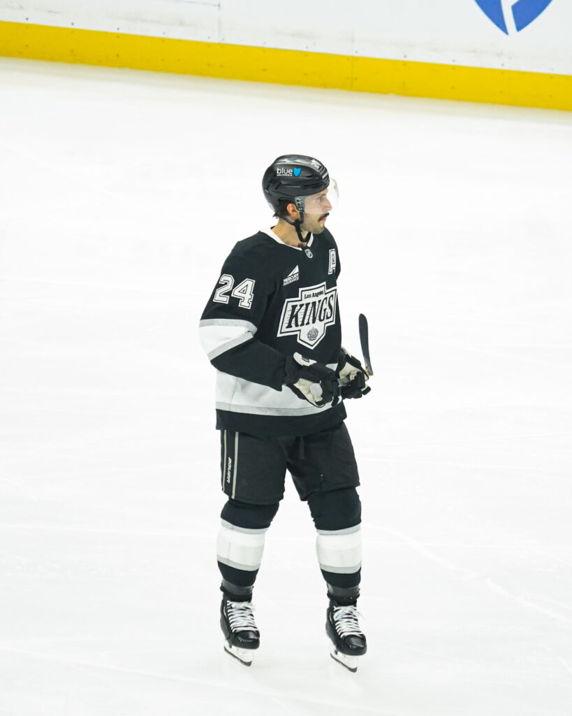 Ice hockey player in black and white uniform on the rink.