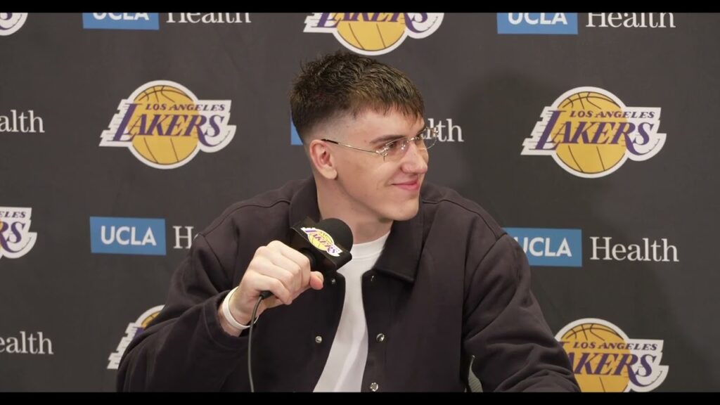 A man speaking at a press conference with a microphone.