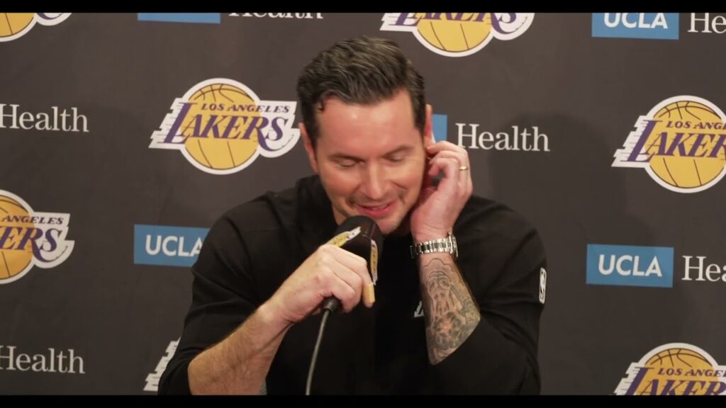 Man speaking at Los Angeles Lakers press conference.