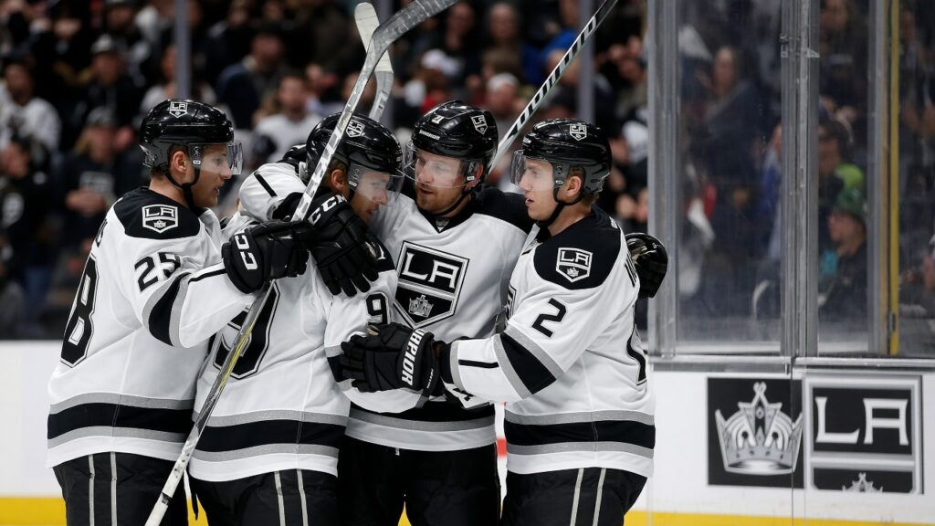 Kings First Win: Adrian Kempe Scores Twice, Erik Gustafsson Wins It as Kings Beat Capitals 5-2 Los Angeles Kings players in white jerseys celebrate a goal along the boards during the Kings first win over the Capitals
